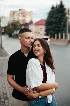 Young couple embracing lovingly in urban setting