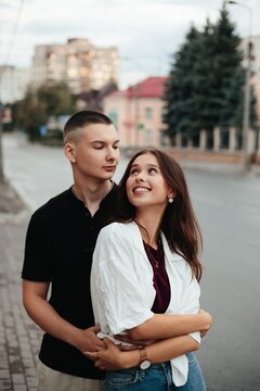 Young couple embracing outdoors expressing love happiness
