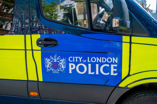 City Police van, street support group vehicle law enforcement officers guarding order, security patrol scene, typical Public safety England UK landmark, Urban policing London, United Kingdom