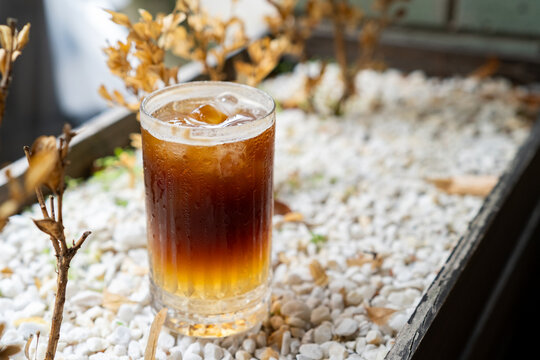 High angle view of iced bumble coffee in wooden planter