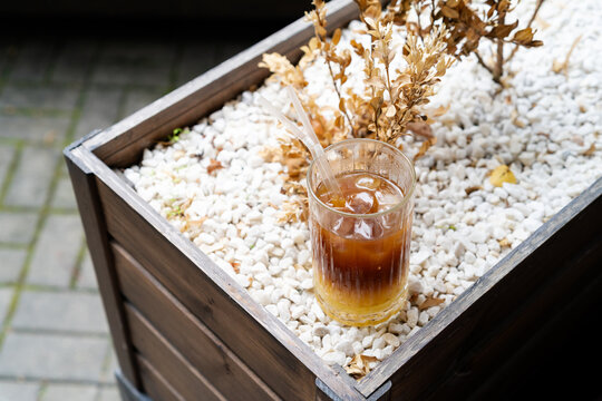 High angle view of iced bumble coffee in wooden planter