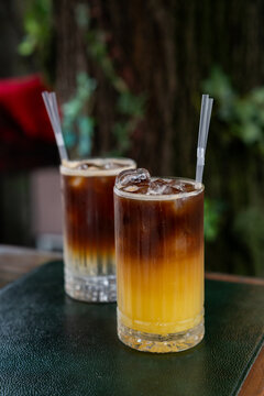 Iced bumble coffee and espresso tonic on outdoor cafe table