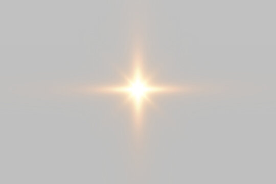 Golden glowing star burst with bright light rays on black background
