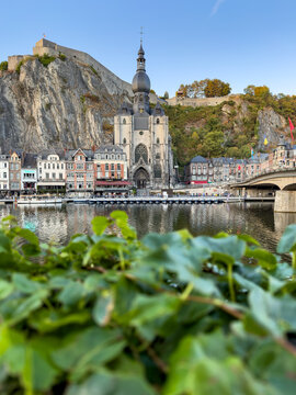 View of the Collegiate Church of Our Lady of Dinant and the Citadel towering over the Meuse River in Dinant, Wallonia, Belgium.