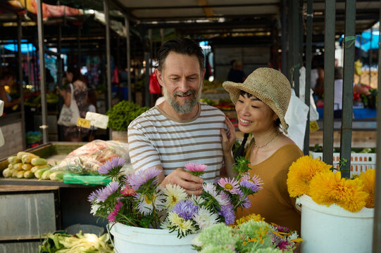 Smiling Couple Buying Flowers At Outdoor Farmers Market &mdash; Asian Woman And Man Enjoy Shopping