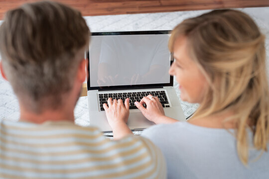Rear view shot of a middle-aged couple using a laptop at home