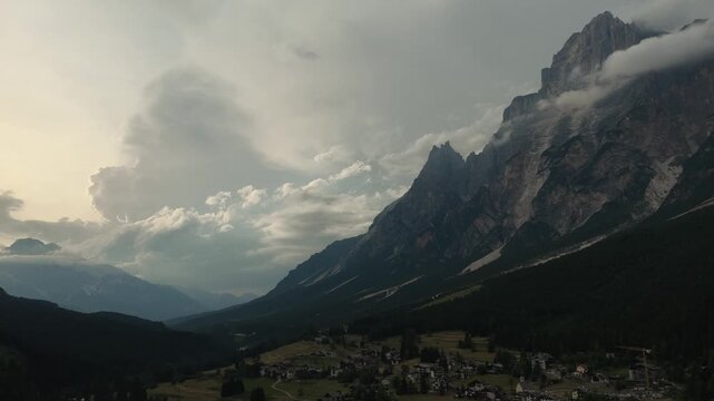 serene mountain landscape at high altitude under cloudy sky with rocky terrain and snow-covered peaks from a high vantage point looking down at the scenic view.