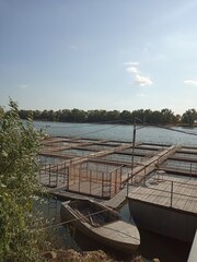 Fish farm cage culture on river for sturgeon and fish breeding with metal cages and wooden pontoon © MIRIAM