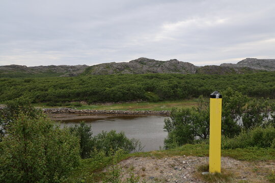 Yellow border marker viewed from the Norwegian side near the Norway-Russia border.