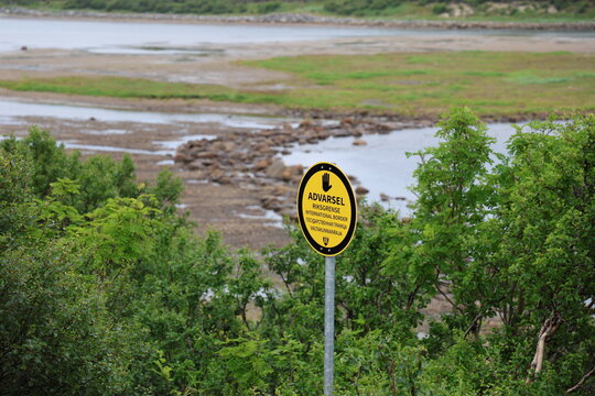 Yellow border marker viewed from the Norwegian side near the Norway-Russia border.