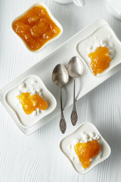 Curd dessert with cream and apricot jam.