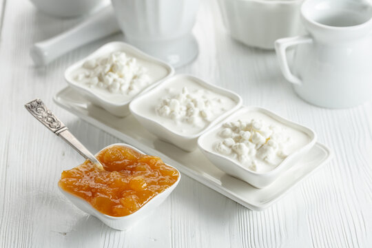 Curd dessert with cream and apricot jam.