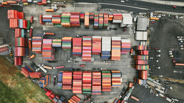 Istanbul, Istanbul, Turkiye - 11 August 2026: Aerial view of a busy shipping container terminal featuring rows of colorful cargo containers, logistics trucks, and paved storage areas.