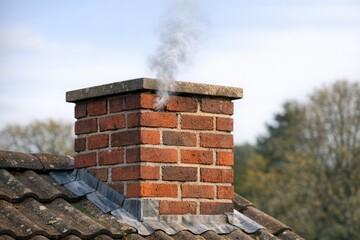 Fototapeta premium A classic chimney with smoke rising from the top