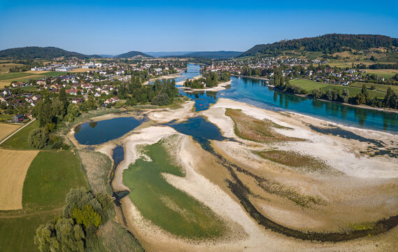 Historical record of  low water on the Lower Rhine river with view of Islet Werd and city Stein am Rhein from drone view, due to continueous heat and drought in Summer 2026.