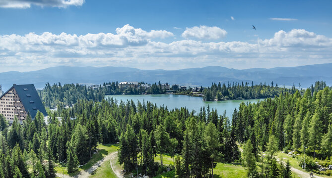 Areal view of the calm lake Strbske pleso lake pf glacial origin in National Park High Tatra, Slovakia, Europe.  Lamdmark and popular tourist destination