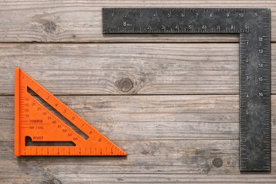 Measurements taken on a wooden workbench with a ruler and a square in place