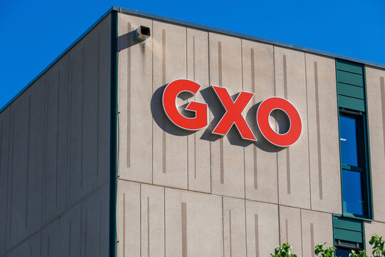 GXO Logistics red logo close-up on warehouse facade in San Antonino