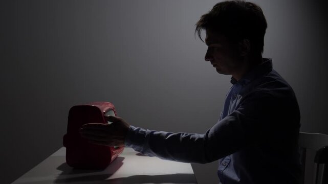 Man feeling frustration and anger, hitting a malfunctioning retro television with his fist, highlighting issues with old technology, communication problems, and stress