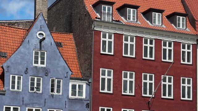 Colorful houses and roofs on historic Nyhavn waterfront, Copenhagen, Denmark