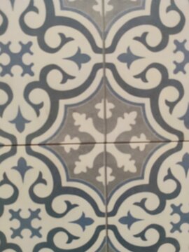 Floral vintage ceramic tile pattern background with grey and white ornaments
