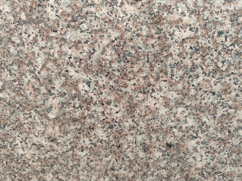 Pink granite stone texture background with polished mineral speckle surface

