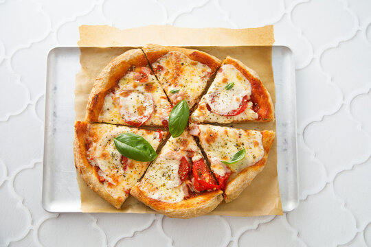 Homemade pizza with tomatoes and mozzarella cheese
