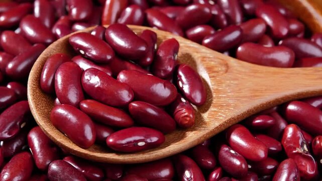 Dried red beans in a wooden spoon