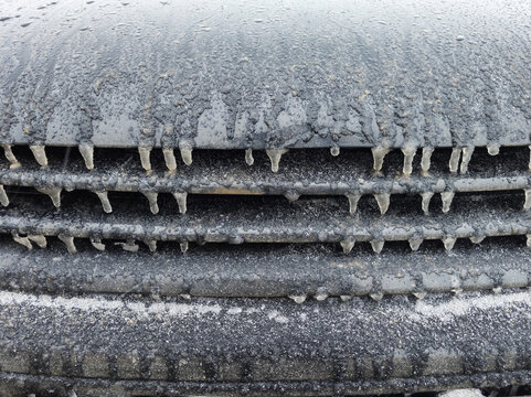 Close-up of Vehicle Grille Covered in Ice and Icicles