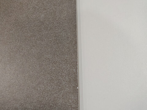 Modern architectural surface texture showing contrast between dark textured material and clean white wall panel. Suitable for interior design, architecture, renovation, construction materials, minimal
