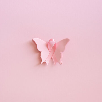 Pink ribbon butterfly on soft pink square background for Breast Cancer Awareness Month support and awareness campaign
