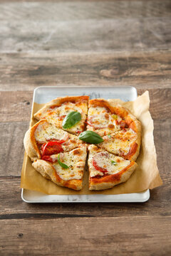 Homemade pizza with tomatoes and mozzarella cheese