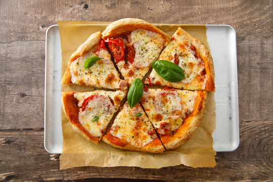 Homemade pizza with tomatoes and mozzarella cheese