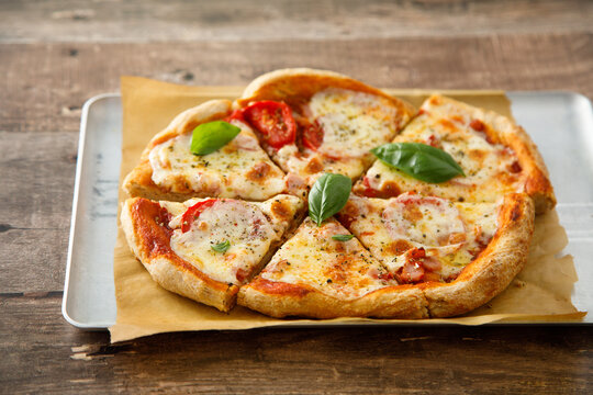 Homemade pizza with tomatoes and mozzarella cheese