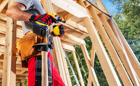 Carpenter using tools at construction site during daytime