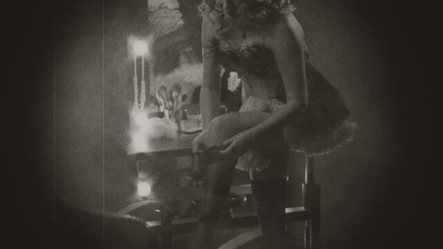 Black and white film sepia color art video close-up hand happy retro lady puts on stockings on legs, short dress. sexy woman beauty face burlesque show dancer. flapper girl 20s roaring old style
