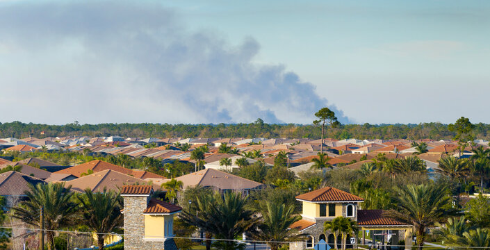 Suburban neighborhood in Florida suffering from bad air quality polluted with prescribed forest fire smoke
