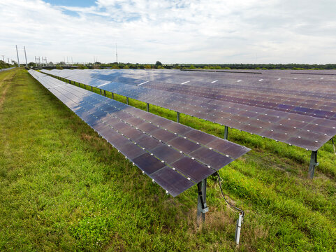 View from above of photovoltaic power plant with many rows of solar panels for producing clean electrical energy. Concept of renewable electricity with no air pollution