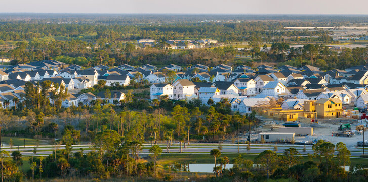 Wooden houses under construction in new developing suburban area. Development of residential housing in American suburbs. Real estate market in the USA