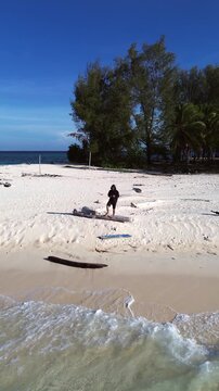 Aerial View of Person Standing on a Tropical Island Beach