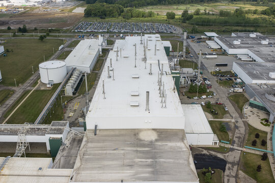 Lansing, United States - 10 August 2026: Aerial view of GM Lansing Delta Assembly featuring large industrial rooftops, ventilation systems, surrounding parking lots, and green fields.