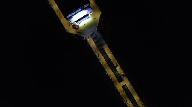 High Angle Night Footage of Illuminated Buildings and Roads with Traffic at Best Tourist Attraction Destination of England at Bournemouth City with Sandy Beach and Ocean of Great Britain, 
