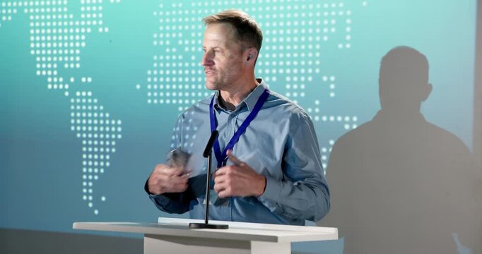 Businessman, speech and thank you with award on podium for nomination or announcement in ceremony. Mature man, speaker or pitch with reward or trophy for business success, achievement or milestone