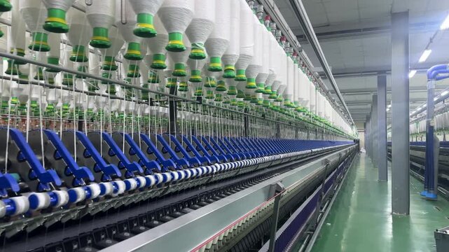 Long Row of Automated Yarn Spinning Machines in Textile Mill