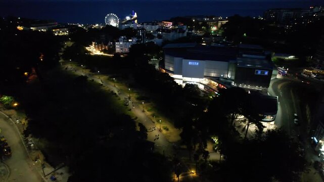 High Angle Night Footage of Illuminated Buildings and Roads with Traffic at Best Tourist Attraction Destination of England at Bournemouth City with Sandy Beach and Ocean of Great Britain, 