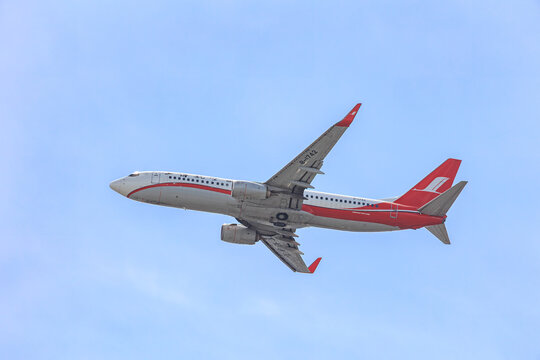 A Shanghai Airlines Boeing 737-800 (B-1742) climbs overhead with winglets catching the light on September 21, 2025 in Fukuoka, Japan.