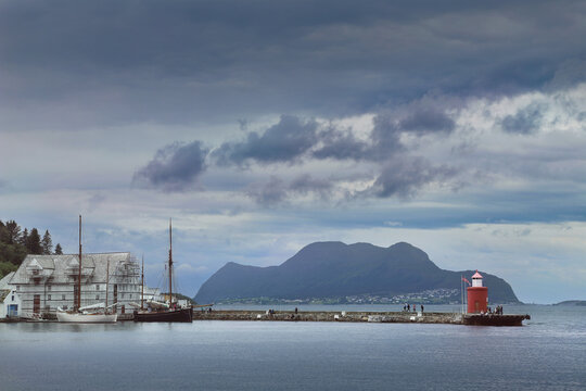 Molja lighthouse under stormy skies in Alesund, Norway. The Crimson Beacon of &Aring;lesund in the Norwegian Fjord.