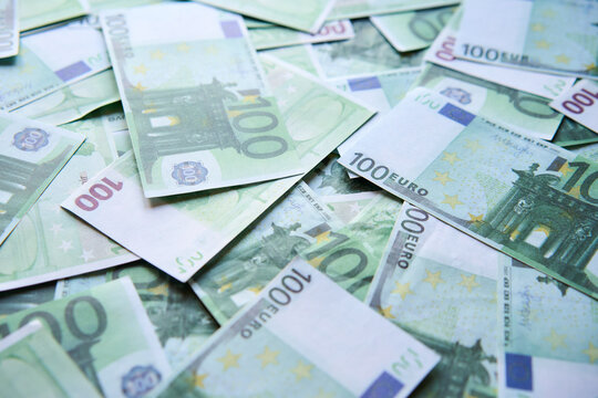 Money background of scattered one hundred euro bills