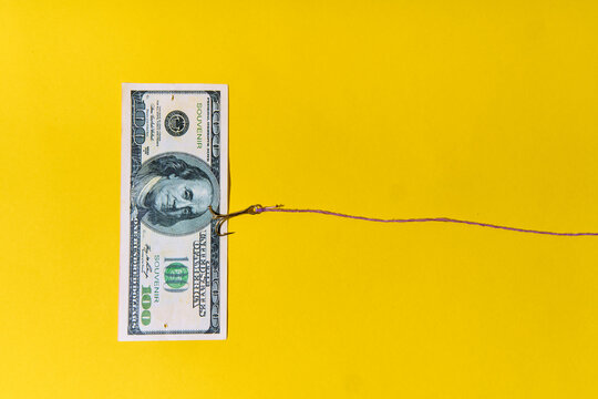 Hundred dollar bill on fishing hook