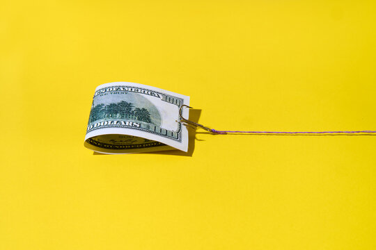 Hundred dollar bill on fishing hook